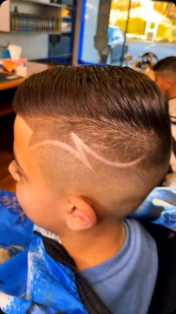 Custom hair design carved into a skin fade